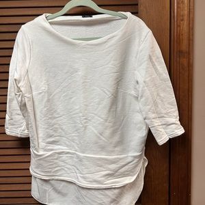 White hi-low pull over.